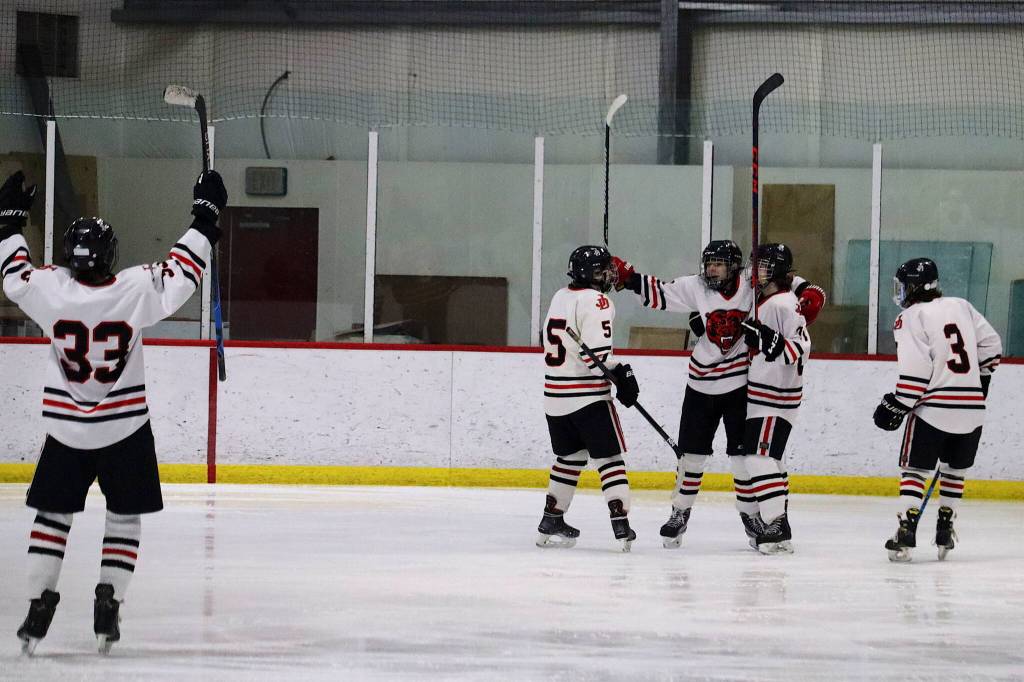 Juneau-Douglas High School: Yadaa.at Kalé players celebrate after scoring one of their 13 goals in a shutout win against Homer High School on Saturday at Treadwell Arena. (Mark Sabbatini / Juneau Empire)