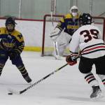 Juneau-Douglas High School: Yadaa.at Kalés Drew Cadigan-Mcadoo (#39) tries to get the puck past a smaller Homer High School player during Saturdays game at Treadwell Arena. (Mark Sabbatini / Juneau Empire)