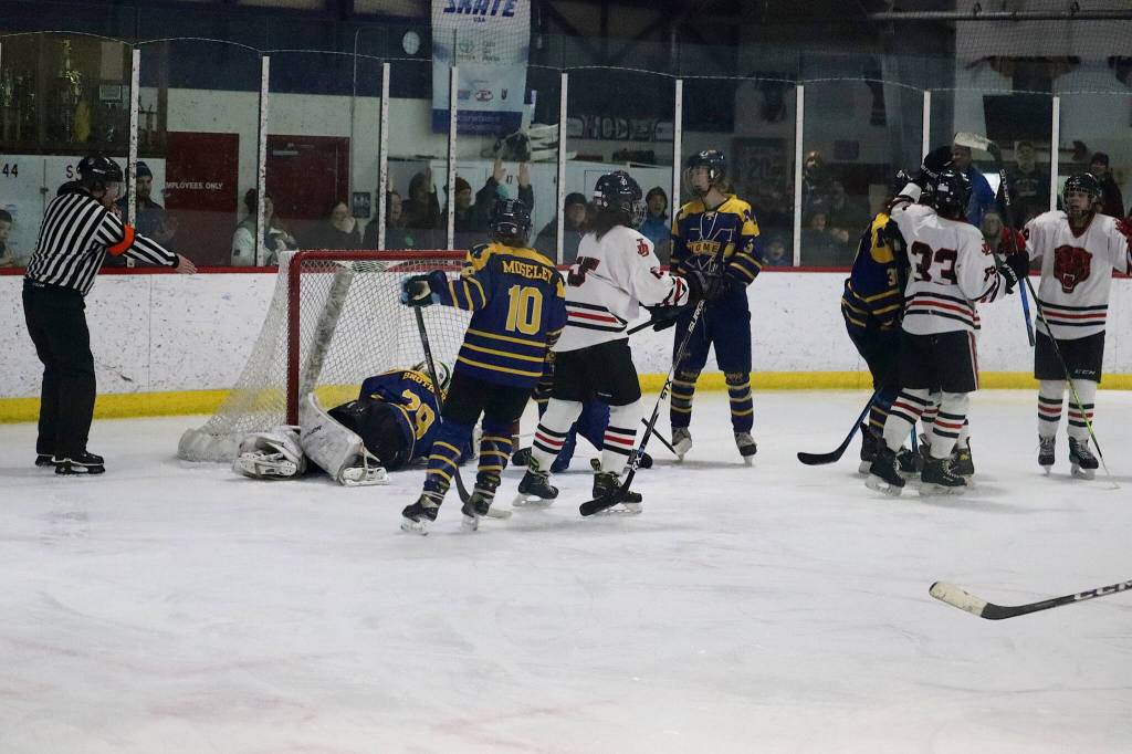 Juneau-Douglas High School: Yadaa.at Kalé players celebrate following the final goal in JDHS 13-0 win Saturday at Treadwell Arena. (Mark Sabbatini / Juneau Empire)