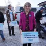 Joelle Hall, president of the Alaska AFL-CIO, carries a box of signed petitions for an increased minimum wage to be delivered to the Alaska Division of Elections on Tuesday. Hall is a leader of the campaign to pass a ballot initiative increasing workers minimum pay, mandating paid sick leave and ensuring that workers are not required to hear employers political, religious or anti-union messages. Behind her are other advocates for the ballot initiative. (Yereth Rosen/Alaska Beacon)
