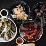 Traditional foods, including herring eggs on kelp, dried pike, smoked salmon, seal oil and dried moose meat, prepared for Dillingham community members and supporters of the Smokehouse Collective, an Alaska Native mutual aid network. (Photo by Emily Sullivan/High Country News)