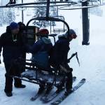 An Eaglecrest Ski Area lift operator helps skiers on Dec. 20. A study published earlier this month states the average wage of $13.06 for Eaglecrest lift operators and attendants is 25% below the average at U.S. ski resorts. (Mark Sabbatini / Juneau Empire file photo)