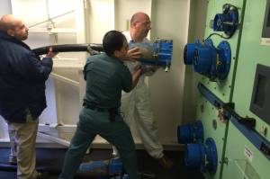 Workers plug a cable into a Princess Cruises ship in Juneau on June 26, 2016. (Photo by John Neary)