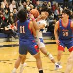 Thunder Mountain High Schools Lance Nierra gets hit with a charging foul during Saturdays game against Sitka High School at TMHS. (Mark Sabbatini / Juneau Empire)