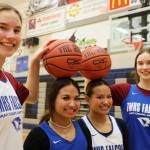 Junior twins Cailynn and Kerra Baxter, outside, and senior twins Jaya and Mikah Carandang, inside, smile for a picture after a practice last season on Feb. 2, 2023, at Thunder Mountain High School. (Clarise Larson / Juneau Empire file photo)