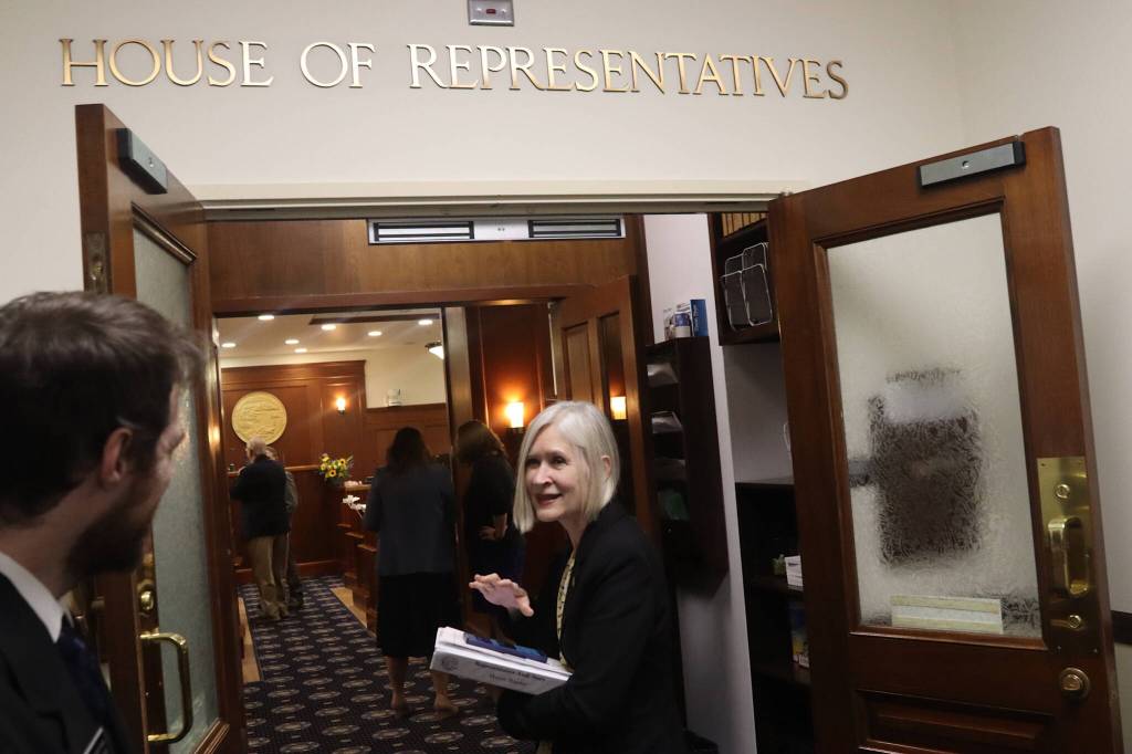 State Rep. Andi Story, a Juneau Democrat, greets a legislative page on her way into the House chambers for the start of Tuesday afternoons floor session. (Mark Sabbatini / Juneau Empire)