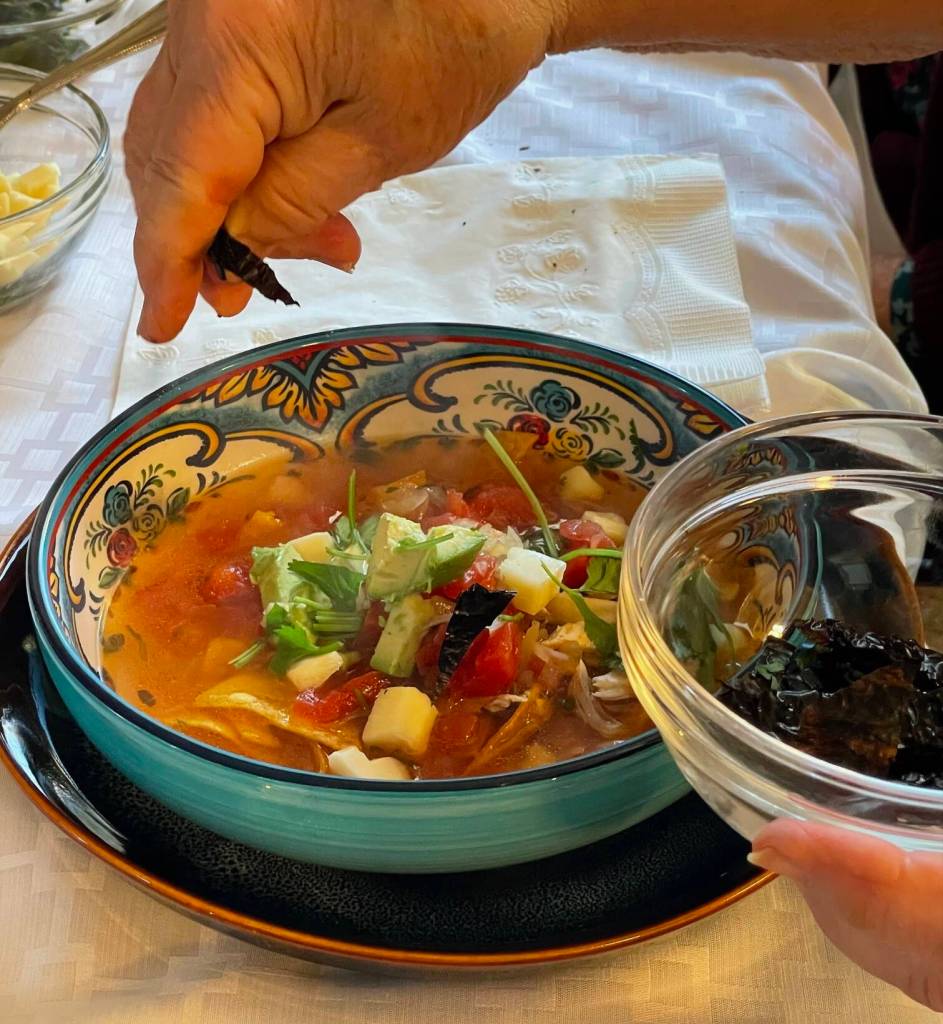 Garnishing a bowl of tortilla soup. (Photo by Laurie Craig)