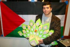 Gaza resident Haytham Mohanna accepts first prize during the State Departments International Education Week in November of 2013 for a presentation he gave in Haines. (Photo by Tom Morphet)