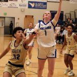Thunder Mountain sophomore Cambry Lockhart (1) scores over South Anchorages Isa Costadasily (32) during the Falcons 73-37 win over the Wolverines on Thursday at the Thunderdome. (Klas Stolpe / For the Juneau Empire)