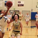 Thunder Mountain senior Jaya Carandang (3) scores past South Anchorage defenders Reese Gebauer (11) and Isa Costadasily (32) during the Falcons 73-37 win over the Wolverines on Thursday at the Thunderdome. (Klas Stolpe / For the Juneau Empire)