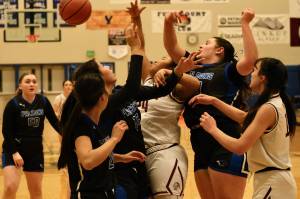 Thunder Mountain junior varsity and Hoonah varsity players battle for a rebound during the inaugural Elizabeth Peratrovich Womens High School Basketball Invitational Tournament on Thursday at Thunder Mountain High School. The tournament runs through Saturday. (Klas Stolpe / For the Juneau Empire)