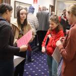 From left, Bela Pyare, 13, Josie Elfers, 11, Nayeli Hood, 11, and Emily Ferry, a member of the Alaska Association of School Boards, discuss their testimony about a board-based education bill in a hallway at the Alaska State Capitol during a House Rule Committee meeting on Saturday. (Mark Sabbatini / Juneau Empire)