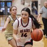 Layla Tokuoka (14) tries to drive inside for Juneau-Douglas High School: Yadaa.at Kalé during Saturdays game against South Anchorage High School at JDHS. (Mark Sabbatini / Juneau Empire)