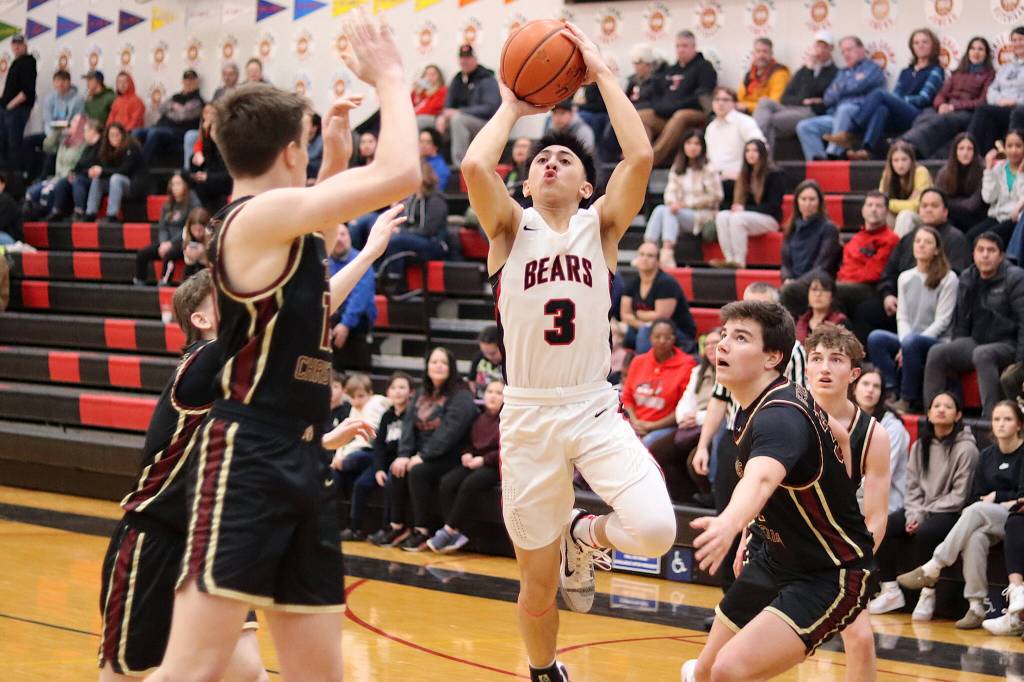 Alwen Carrillo (3) shoots in traffic for Juneau-Douglas High School: Yadaa.at Kalé during Saturday nights game against Grace Christian School at JDHS. (Mark Sabbatini / Juneau Empire)