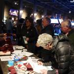 Supporters of U.S. Rep. Mary Peltola sign registration sheets and pick up campaign gear during a meet-and-greet Saturday evening at the Crystal Saloon. (Mark Sabbatini / Juneau Empire)