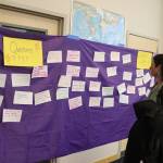 Tana OLeary, a parent of two elementary school students, reads comments from attendees at a Community Budget Input Session at Thunder Mountain High School on Wednesday night. (Mark Sabbatini / Juneau Empire)