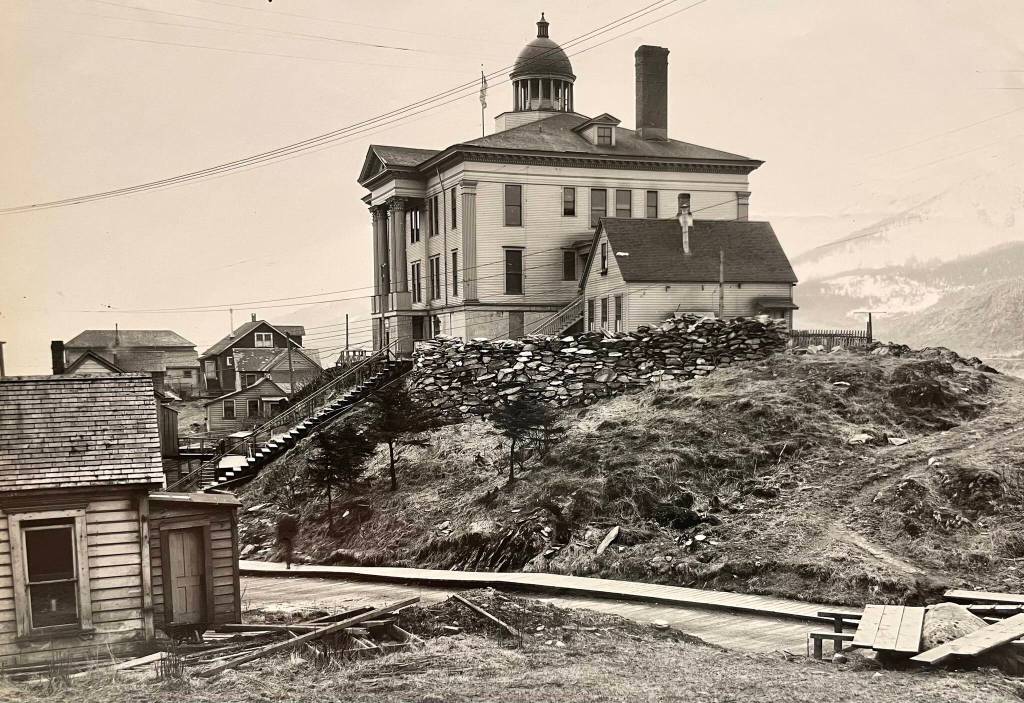 In 1903 a new elegant courthouse was built on the hilltop. Its location and cupola made the imposing building visible from many locations. It was razed in 1969 to make space for the State Office Building that straddles the hill from Calhoun Street to Willoughby Street. (Alaska State Library PCA 01-1073)