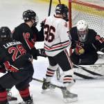 Kenai Central goalie Evyn Witt makes a save in front of Juneau-Douglas High School: Yadaa.at Kales Elliot Welch on Thursday at the Division II state hockey tournament at the Soldotna Regional Sports Complex in Soldotna. (Jeff Helminiak/Peninsula Clarion)
