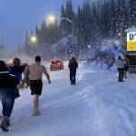 Fairbanks residents engage in a favorite cold-weather activity of taking photographs of themselves in front of the University of Alaska Fairbanks time-and-temperature sign on the morning of Jan. 27, 2024. (Photo by Ned Rozell)