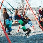 Students swing on a playground at Meadow Lakes Head Start in Wasilla. (Image by Lela Seiler, courtesy of CCS Early Learning)