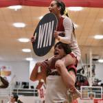 Members of the Juneau-Douglas High School: Yadaa.at Kalé cheer squad show their spirit during Saturdays Crimson Bears basketball game against Kodiak. (Klas Stolpe/For the Juneau Empire)