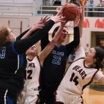 Thunder Mountain High School senior Kara Strong, Juneau-Douglas High School: Yadaa.at Kalé junior Nadia Wilson (12), TMHS junior Kerra Baxter (22) and JDHS freshman Layla Tokuoka (14) battle for a rebound during the Falcons 42-28 win over the Crimson Bears on Saturday at the George Houston Gymnasium. (Klas Stolpe/For the Juneau Empire)