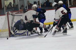 Juneau-Douglas High School: Yadaa.at Kalés Caden Johns (#5), seen here in a Dec. 16, 2023, game against Palmer High School, was the lone JDHS player named to the all-tournament team during the Division II state hockey tournament in that concluded Saturday in Soldotna. Luke Bovitz (#4) was one of two key players missing during the tournament due to injuries. The Crimson Bears finished fourth in the tournament. (Mark Sabbatini / Juneau Empire file photo)