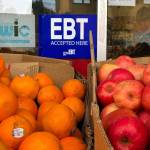 A sign noting the acceptance of electronic benefit transfer (EBT) cards that are used by state welfare departments to issue benefits is displayed at a grocery store on Dec. 4, 2019, in Oakland, California. (Photo by Justin Sullivan/Getty Images)