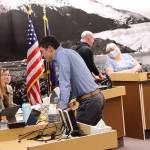 Juneau Assembly members and city administrators confer during a finance committee meeting Wednesday night about specific wording for portions of a proposed financial bailout package for the Juneau School District. (Mark Sabbatini / Juneau Empire)
