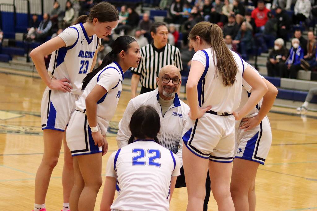 Thunder Mountain High School Head Coach Andy Lee confers with his players during a timeout in Saturdays game against Ketchikan High School at TMHS. (Mark Sabbatini / Juneau Empire)