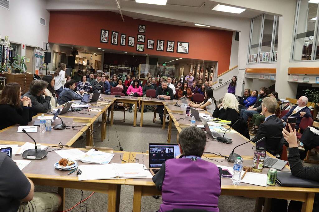Juneau School District board members and administrators listen to public testimony during a meeting Tuesday night at Juneau-Douglas High School: Yadaa.at Kalé. (Mark Sabbatini / Juneau Empire)