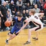 Samuel Lockhart (#14) of Thunder Mountain High School tries to get past Sean Oliver of Juneau-Douglas High School: Yadaa.at Kalé during Wednesday nights game at JDHS. (Mark Sabbatini / Juneau Empire)