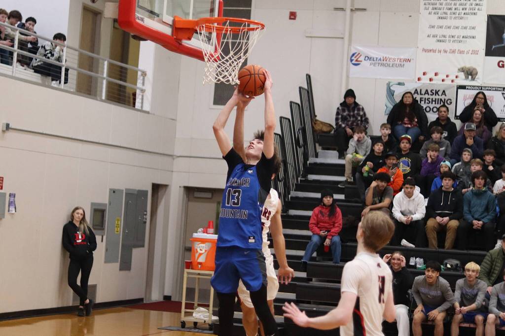 Kasen Ludeman is fouled while taking a shot for Thunder Mountain High School against Juneau-Douglas High School: Yadaa.at Kalé on Wednesday at JDHS. (Mark Sabbatini / Juneau Empire)