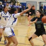 Thunder Mountain High School twins Jaya Carandang (#3) and Mika Carandang (#4) try to trap Colony High Schools Alycia Shelley during Saturdays game at TMHS. (Mark Sabbatini / Juneau Empire)