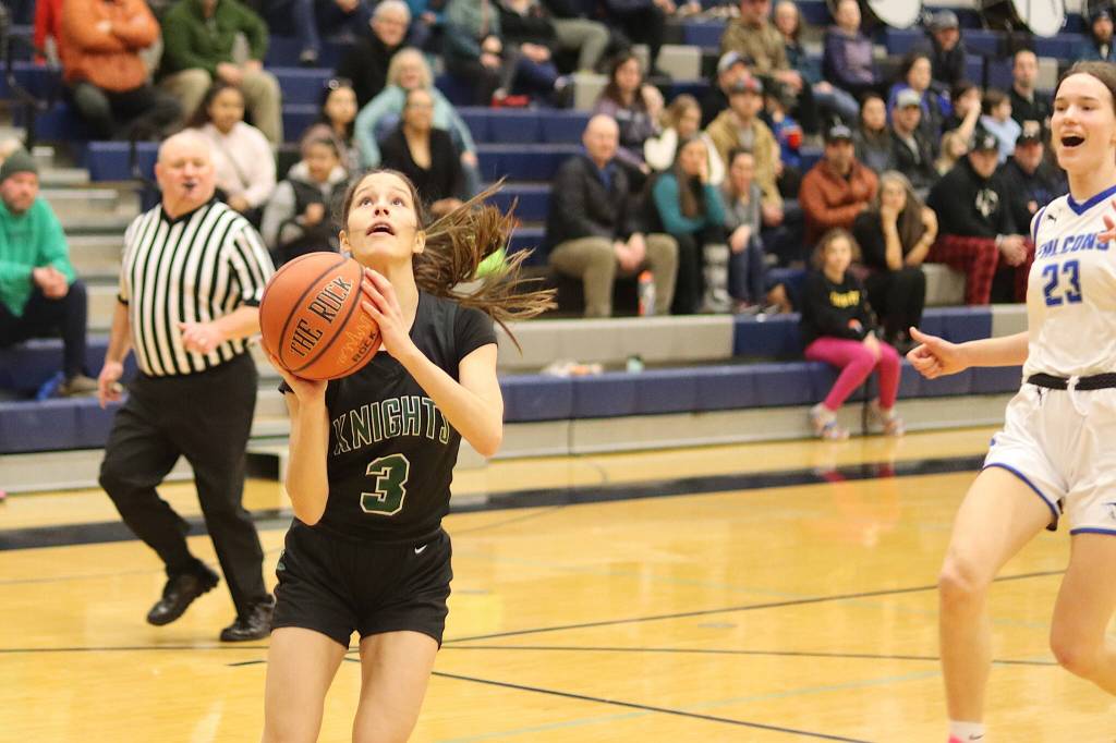 Thunder Mountain High Schools Cailynn Baxter (#23) tries to spook Colony High Schools Bella Shelley as she attempts a breakaway shot during Saturdays game at TMHS. (Mark Sabbatini / Juneau Empire)