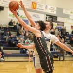 Ketchikan High Schools Marcus Stockhausen tries to get a shot past Thunder Mountain High Schools James Polasky during Saturdays game at TMHS. (Mark Sabbatini / Juneau Empire)