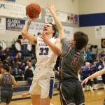 Thunder Mountain High Schools Thomas Baxter (#33) takes a shot under the basket against Ketchikan High Schools Jonathan Scoblic during Saturdays game at TMHS. (Mark Sabbatini / Juneau Empire)