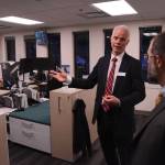 Deven Mitchell, executive director of the Alaska Permanent Fund Corp., gives a tour of the corporations investment floor to Sen. Jesse Kiehl, D-Juneau, and other attendees of an open house on Friday. (James Brooks/Alaska Beacon)