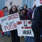 Juneau-Douglas High School: Yadaa.at Kalé students hold up signs during a rally along Egan Drive on Tuesday afternoon protesting a proposal to consolidate all local students in grades 10-12 at Thunder Mountain High School to help deal with the Juneau School Districts financial crisis. (Mark Sabbatini / Juneau Empire)