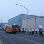 Dozens of students, teachers and supporters of Juneau-Douglas High School: Yadaa.at Kalé participate in a rally Tuesday afternoon along Egan Drive to protest a proposal consolidating all local students in grades 10-12 at Thunder Mountain High School. (Mark Sabbatini / Juneau Empire)
