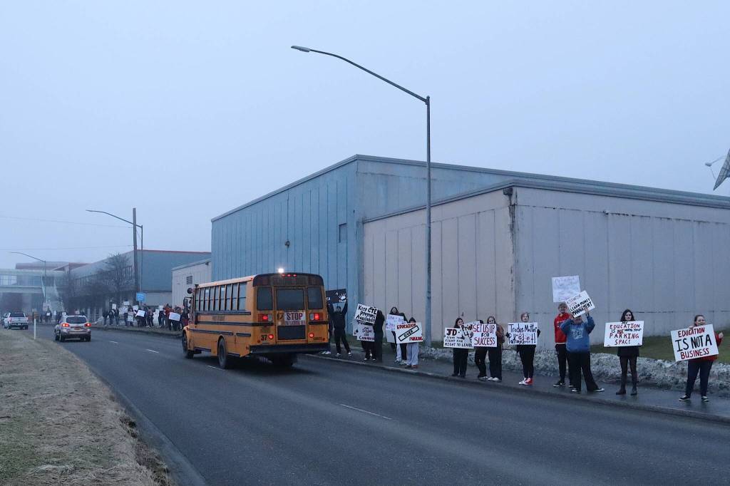 Dozens of students, teachers and supporters of Juneau-Douglas High School: Yadaa.at Kalé participate in a rally Tuesday afternoon along Egan Drive to protest a proposal consolidating all local students in grades 10-12 at Thunder Mountain High School. (Mark Sabbatini / Juneau Empire)