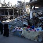 Palestinians sell goods next to buildings destroyed by an Israeli airstrike in Rafah, Gaza Strip, Wednesday, Feb. 21, 2024. An estimated 1.5 million Palestinians displaced by the war took refuge in Rafahor, which is likely Israels next focus in its war against Hamas. (AP Photo/Fatima Shbair)