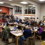 A crowd overflows the library at Juneau-Douglas High School: Yadaa.at Kalé on Thursday night as school board members meet to select a consolidation option to help resolve the Juneau School Districts budget crisis. (Mark Sabbatini / Juneau Empire)