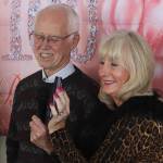 Fred Baxter and Berta Winther accept a call from U.S. Sen. Lisa Murkowski congratulating Jirdes Winther Baxter during her 100th birthday celebration at the Juneau Yacht Club on Saturday. (Mark Sabbatini / Juneau Empire)