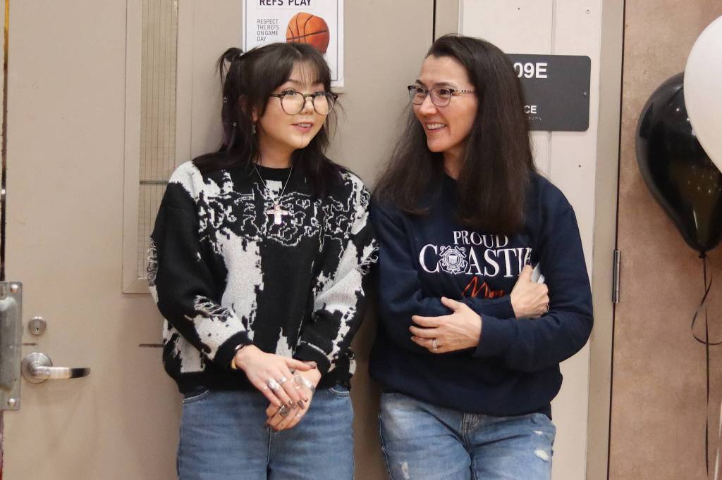 U.S. Rep. Mary Peltola and her daughter, Nora Nelson, a student at Juneau-Douglas High School: Yadaa.at Kalé, watch the JDHS versus Thunder Mountain High School boys basketball game at JDHS on Saturday night.(Mark Sabbatini / Juneau Empire)
