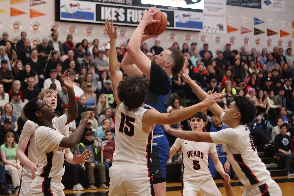 Thunder Mountain High Schools James Polasky goes up for a shot surrounded by all five players for Juneau-Douglas High School: Yadaa.at Kalé during Saturdays game at JDHS. (Mark Sabbatini / Juneau Empire)