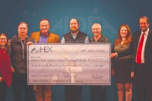 HEX Cook Inlet, LLC and Subsidiaries presents a check to the Alaska Industrial Development and Export Administration in October of 2023. (Photo courtesy of the Alaska Industrial Development and Export Administration)
