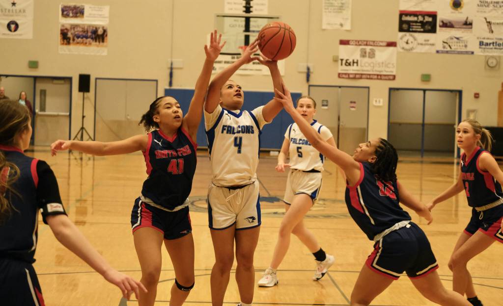 Thunder Mountain High Schools Mikah Carandang is fouled by North Poles Jade Skipps. (Klas Stolpe / For the Juneau Empire)
