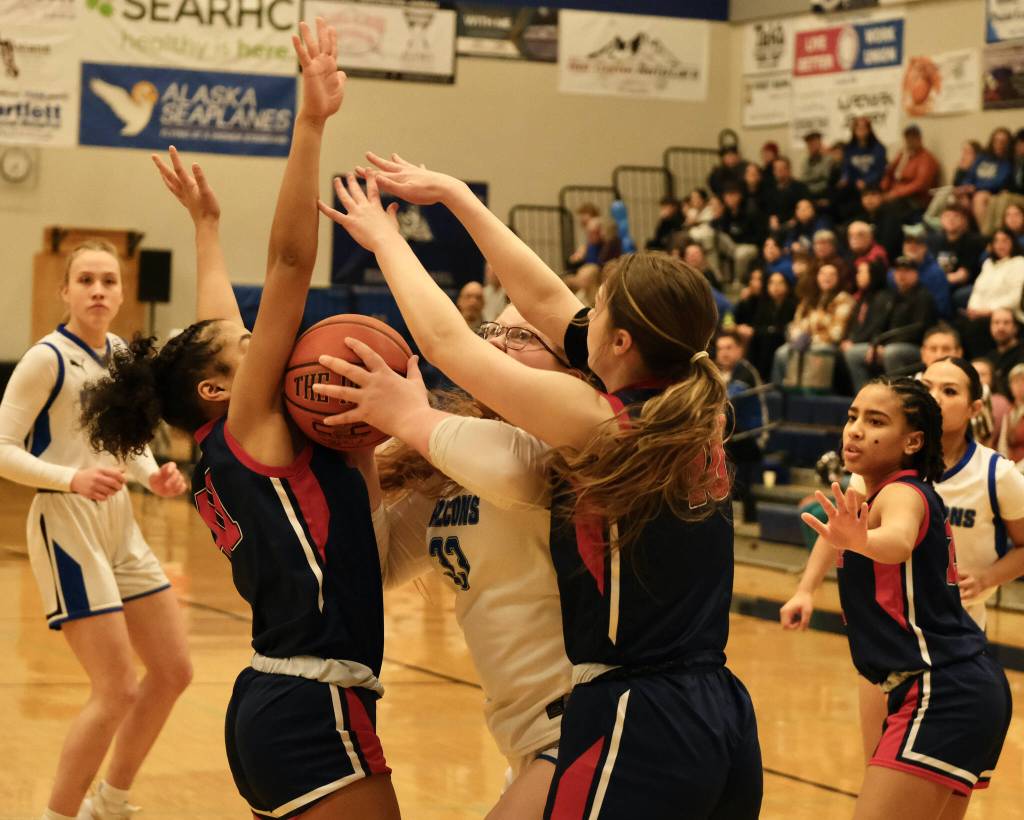 Thunder Mountain High School senior Kara Strong (33) looks to score against North Poles Taimone Skipps (41) and Madi Glynn (10) during the Falcons 36-31 win over the Patriots Saturday at the Thunderdome. (Klas Stolpe / For the Juneau Empire)