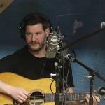 Josh Fortenbery records a song from his debut album No Such Thing as Forever while sitting in an improvised sound isolation booth at the KTOO studios in early 2023. (Mark Sabbatini / Juneau Empire)
